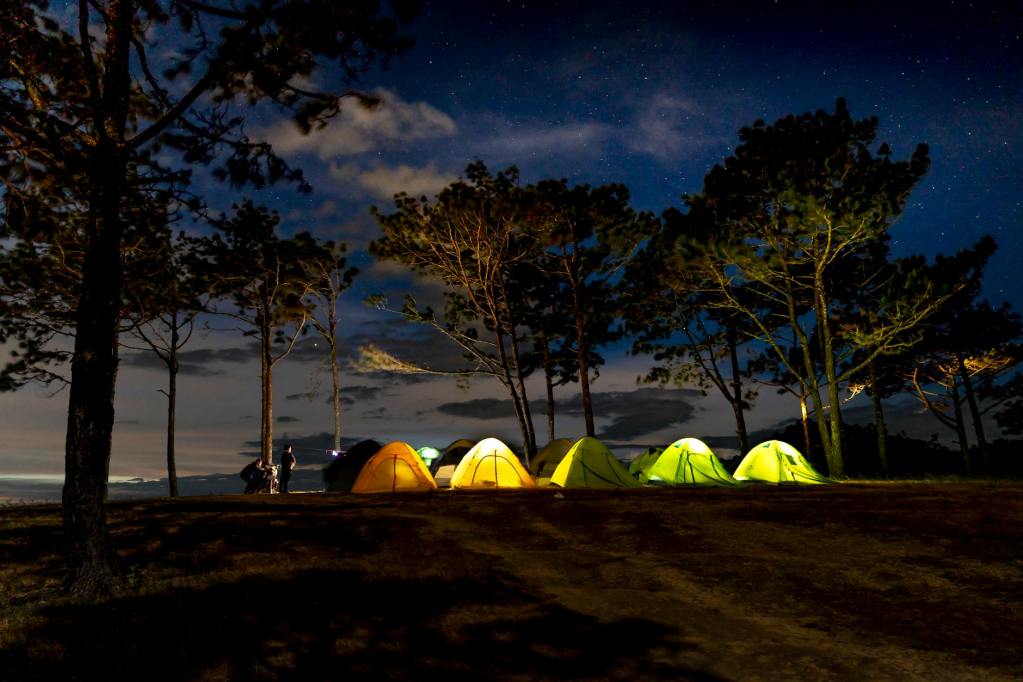 illuminated campsite at dusk
